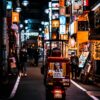 red and black auto rickshaw on road during nighttime