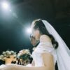 wedding couple near flower arrangements