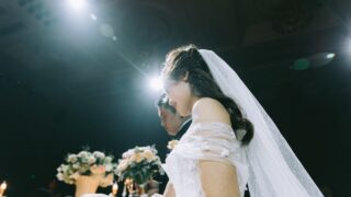 wedding couple near flower arrangements