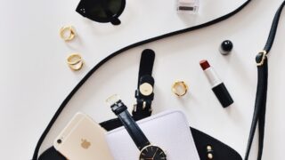 women's sunglasses and black bag with watch and iPhone 6