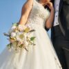 woman in white wedding dress holding bouquet of white flowers