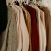 brown and white coat hanged on rack