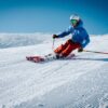 man ice skiing on hill