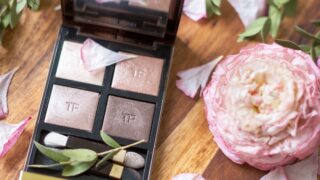 makeup palette beside pink flowers