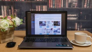 black laptop computer on brown wooden table